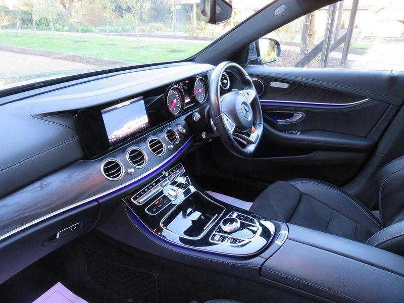 Mercedes-Benz E-Class dashboard interior with ambient purple lighting and digital instrument cluster — Travel in Style Essex